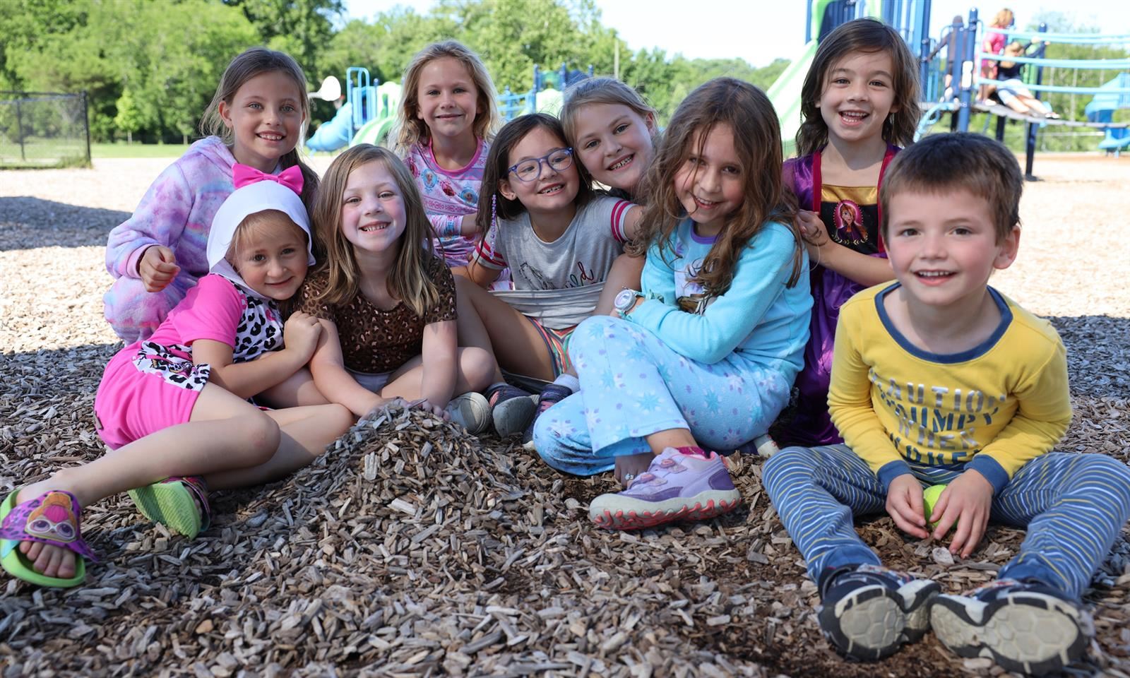 A group of students take a photo on a playground